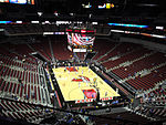 A basketball arena with a Louisville Cardinals logo at center court