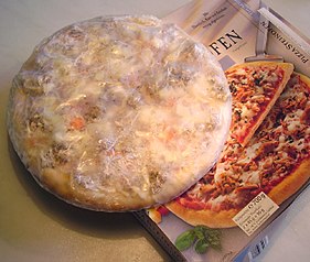 A wrapped, mass-produced frozen pizza cooked at home