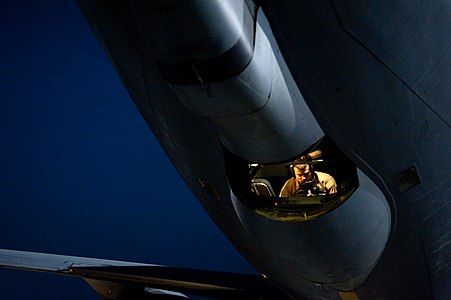 (A boom operator in a USAF KC-135 conducts a preflight inspection in the boom pod prior to a mission in the Middle East.]])