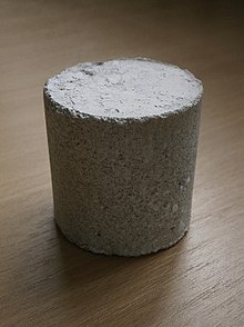 A cylinder of grey gypsum concrete