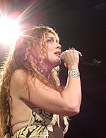 A shot of Faith Hill singing onto a mic from a lower angle