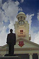 Statue of Tan Kah Kee in front of the clock tower of Hwa Chong Institution, Singapore.