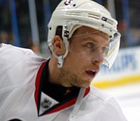 Man's head wearing hockey helmet