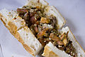 Kokoretsi with tomatoes and spices, served on bread in Eminönü