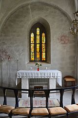 Choir with two consecration crosses painted on the wall.