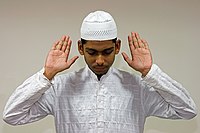 Muslim men traditionally wear white robes and a cap during prayers.