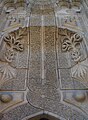 The highly ornamented stone facade of the entrance of the İnce Minareli Medrese