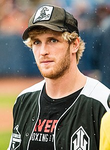 Headshot of Logan Paul, a young, white, blond man with a beard, wearing a boxing shirt and .