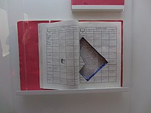 The photo shows a Christian liturgy guidebook used by the Red Army Faction to smuggle a pistol during the trials. This book was later displayed in an exhibition about the RAF in Stuttgart.