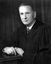 Black-and-white picture of Charles Whittaker in formal attire with a serious look