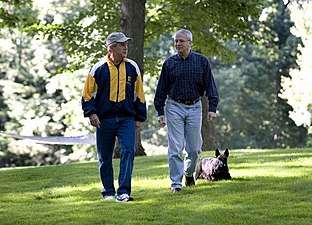 President George W. Bush and Chief of Staff Josh Bolten walk together with the President's dog Barney at Camp David, July 21, 2007.