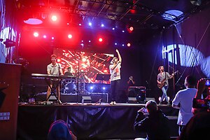 AJR performing "Bang!" in 2013. Ryan playing an electronic keyboard, Jack singing, and Adam playing a bass guitar. (pictured, left-to-right)