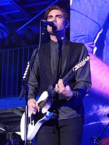 Simpson performing with Busted at the Manchester Arena, 2016