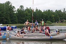 Troops lining up to compete in the Canoe Tug of War event. Two canoes are tied together and competing troops paddles as hard as they can to overpower the opponent canoe.