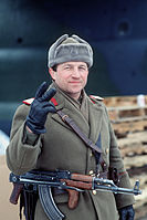 A Romanian sub-officer gives the victory sign on New Year's Eve 1989. He has removed the communist insignia from his ushanka.