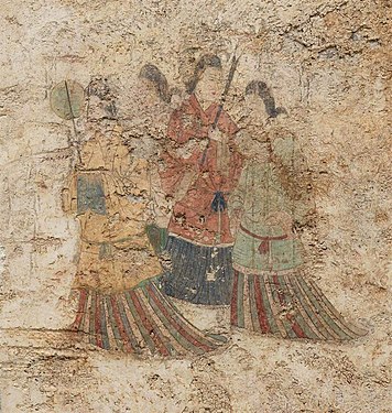 Women's dress under tang dynasty influence, with overlapping collar and mo skirt.[16] Takamatsuzuka Tomb, c. 686 CE.[17]