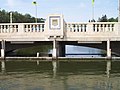 The dam of Albert Memorial Bridge with a terracotta representation of the Saskatchewan coat of arms above