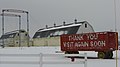 Two white wooden barns and a red wooden rail car