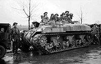 Troops sat in the top of a turretless tank