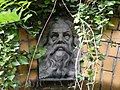 Stone face keystone on the arched doorway of a building circa 1930