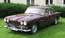 Purple 1960s four-door parked on grass