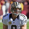 Headshot of Drew Brees in full uniform and helmet on a football field