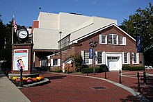 Entrance to the theater Paper Mill Playhouse with the poster to a play outside it.