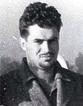 A young white male with dark hair, facing the camera. The image is in black and white.