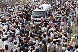 Pakistanis surround an ambulance carrying the body of rebel cleric Abdul Rashid Ghazi during his funeral in Basti Abdullah, Pakistan.