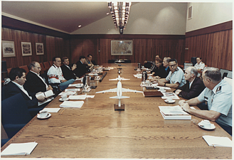 George H. W. Bush meets with his National Security advisors in the Laurel Lodge conference room on August 4, 1990.