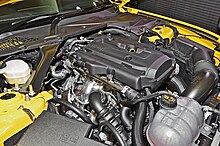 The front inline-four engine of a yellow car