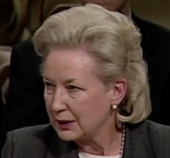 Color photographic portrait of a blonde woman seeming to speak