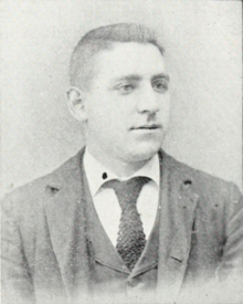 Head and shoulders of a man in a suit and tie