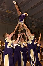 College cheerleaders doing as flipping transition