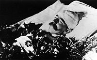 Crown Prince Rudolf placed in a bed for private viewing by his family at the Hofburg Palace in Vienna. His head had to be bandaged in order to cover gunshot wounds. When he later lay-in-state, his skull was reconstructed using wax so that his appearance appeared normal.