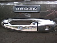 Outside door handle of a 1998 Lincoln Town Car, featuring digital lock.