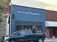 A square blue store with the signage reading "MacLellan Bagpipes" on the front