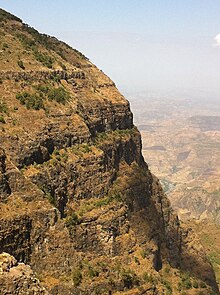 Photo of a cliff face showing layers of basalt lava flows