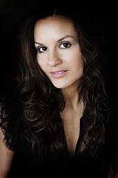 Closeup of a woman with dark, curly hair