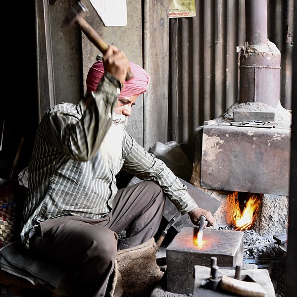 File:Blacksmith working 3.jpg