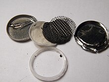 Inside pieces of a coin battery, refer to caption