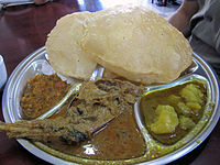 Puri (top) and mutton curry (middle bottom)