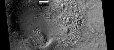 Layered structure in crater that is probably what is left of a layered unit that once covered a much larger area. Material for this unit fell from the sky as ice-coated dust. The picture was taken by HiRISE, under the HiWish program. Picture is from Hellas quadrangle.