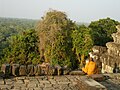 Khmer monk in meditation at Phnom Bakheng in Angkor, Cambodia.