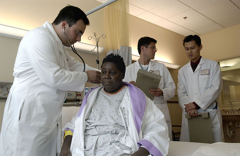 File:Doctor examines patient.jpg