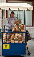 A street vendor in Kraków, Poland, selling pretzels (labeled precle in Polish), as well as obwarzanki krakowskie