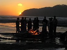 Troop having fun with a campfire on the Meriwether beach