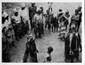 A masked Bundu dancer with her retinue, Panguma, 1936