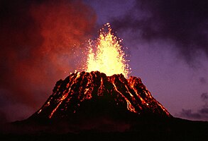 Puʻu ʻŌʻō, a parasitic cinder cone on Kīlauea, lava fountaining at dusk in June 1983, near the start of its current eruptive cycle.