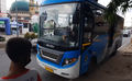 BRT Banjarbakula bus approaching a bus stop